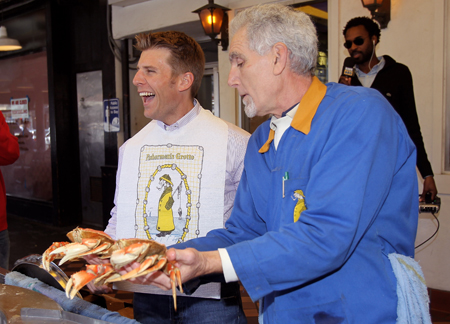Daytona 500 champion Jamie McMurray gets lessons on how to cook and crack a crab from Anthony Geraldi, co-owner of Grotto No. 9 at Fisherman's Wharf during his victory tour of San Francisco on February 17, 2010 in San Francisco, California. (Photo by Ezra Shaw/Getty Images)