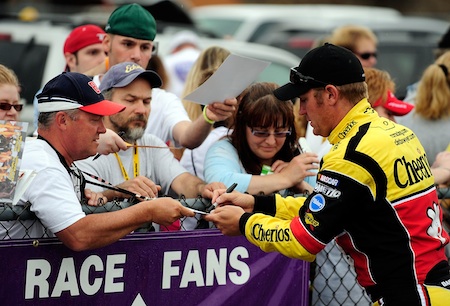 NASCAR Sprint Cup Series driver Clint Bowyer signs autographs for fans on the way to his car during practice Friday at Michigan International Speedway in Brooklyn, Mich. (Credit: Sam Greenwood/Getty Images for NASCAR)