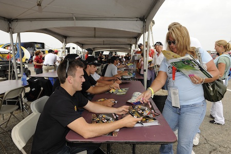 After the rain stopped on Friday at Michigan International Speedway in Brooklyn, Mich., 23 NASCAR Camping World Truck Series drivers -- including Austin Dillon (foreground) -- signed autographs for 400 fans in the Truck garage. (Credit: Rusty Jarrett/Getty Images for NASCAR)
