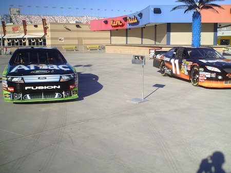 The No. 99 Aflac Ford and No. 11 FedEx Toyota on display for the Chasers for Charity Fanfest inside the Neon Garage at Las Vegas Motor Speedway on Wednesday, December 1, 2010.