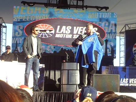 Jimmie Johnson helps auction off a jacket that was signed by all 12 of the Chase drivers
