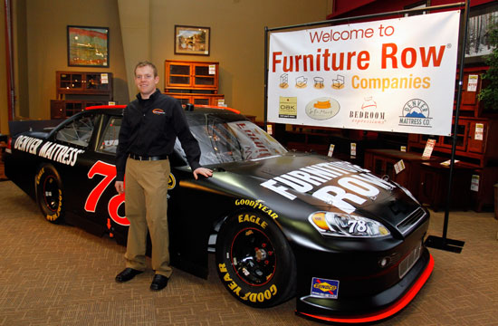 NASCAR Sprint Cup Series driver Regan Smith stands in front of his No. 78 Furniture Row ride during the Sprint Media Tour hosted byCharlotte Motor Speedway on Wednesday in Charlotte, N.C. (Credit: Jason Smith/Getty Images for NASCAR)