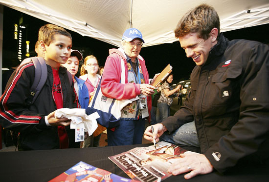NASCAR Sprint Cup Series driver Carl Edwards signs autographs for young fans during the Preseason Thunder Fan Fest following testing Thursday at Daytona International Speedway in Daytona Beach, Fla. (Credit: Jerry Markland/Getty Images for NASCAR)