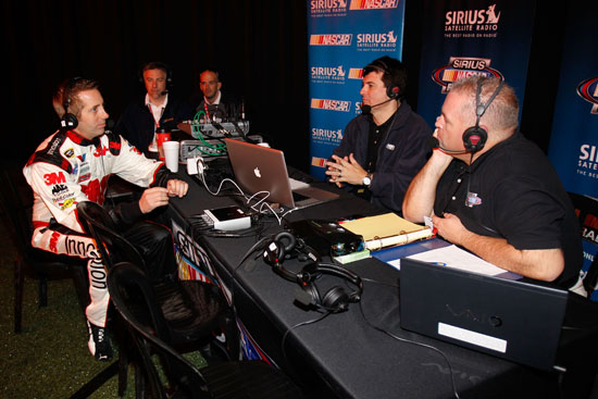 NASCAR Sprint Cup Series driver Greg Biffle talks with Pete Pistone and Mike Bagley from The Morning Drive on Sirius during media day Thursday at Daytona International Speedway in Daytona Beach, Fla. (Credit: Todd Warshaw/Getty Images for NASCAR)