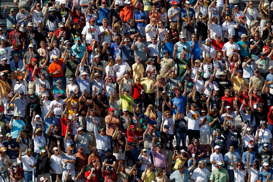 The fans salute Dale Earnhardt on lap 3 by holding up three fingers during the Daytona 500 at Daytona International Speedway at Daytona Beach, Fla. (Credit: Todd Warshaw/Getty Images for NASCAR)