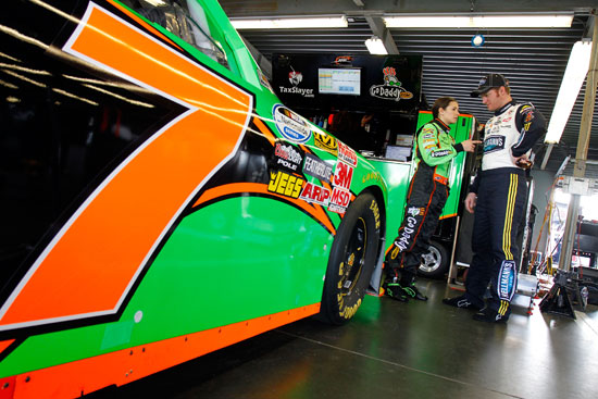 Danica Patrick talks to Dale Earnhardt Jr. about the No.7 GoDaddy.com Chevrolet in the Garage during practice at Daytona International Speedway in Daytona Beach, Fla. (Credit: Jason Smith/Getty Images for NASCAR)