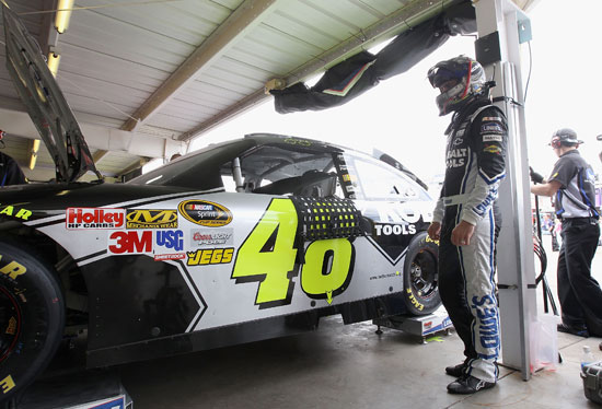 Five-time defending NASCAR Sprint Cup Series driver Jimmie Johnson looks on as his team adjusts his No. 48 Lowe's Chevrolet during practice for the SUBWAY Fresh Fit 500 at Phoenix International Raceway. (Credit: Christian Peterson/Getty Images)