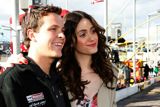 Actress Emmy Rossum, who sang the national anthem, poses with Daytona 500 champion Trevor Bayne before getting a ride around Phoenix International Raceway. (Credit: Chris Graythen/Getty Images)