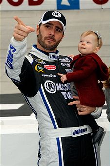 Jimmie Johnson hold his daughter, Genevieve, before the start of the Jeff Byrd 500 at Bristol Motor Speedway