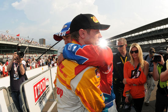 Ryan Hunter Reay gets a hug from Graham Rahal while his Ryan's fiancee, Beccy Gordon, looks on.