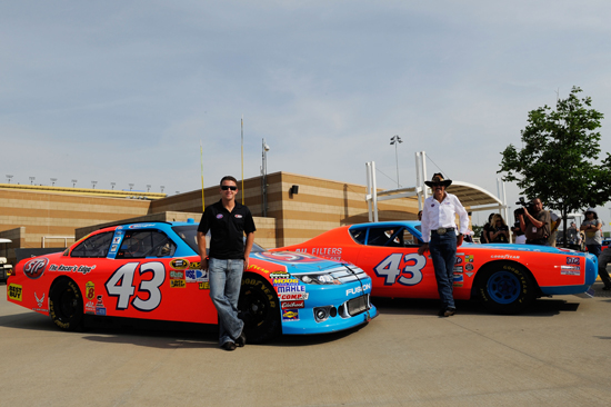 (Left to right) AJ Allmendinger stands next to his 2011 NASCAR Sprint Cup Series car as NASCAR Hall of Famer Richard Petty stands beside his iconic STP ride as the sponsor returns to the sport on Friday at Kansas Speedway in Kansas City, Kan. (Credit: John Harrelson/Getty Images for NASCAR)