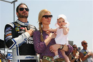 Jimmie Johnson, driver of the #48 Lowe's Chevrolet, his daughter Genevieve Marie and his wife Chandra take part in pre race ceremonies for the NASCAR Sprint Cup Series STP 400 at Kansas Speedway on June 5, 2011 in Kansas City, Kansas. (Photo by Tim Umphrey/Getty Images for NASCAR) 