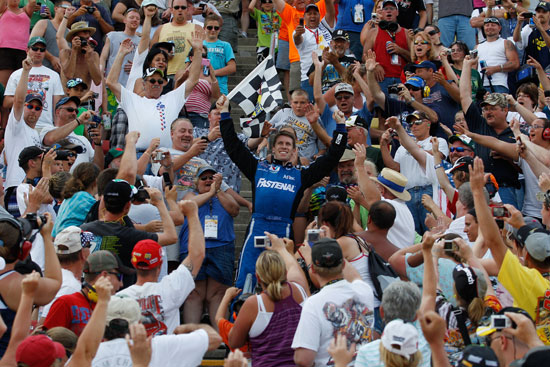 Carl Edwards climbs into the Michigan International Speedway grandstands to celebrate his Alliance Truck Parts 250 victory with the fans. (Credit: Chris Graythen/Getty Images)