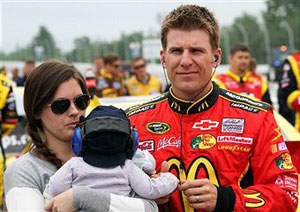 Jamie McMurray, driver of the #1 McDonald's Chevrolet, his wife Christy and child Carter Scott stand on the grid during pre-race ceremonies for the NASCAR Sprint Cup Series 5-Hour Energy 500 at Pocono Raceway on June 12, 2011 in Long Pond, Pennsylvania. (Photo by Jerry Markland/Getty Images for NASCAR)