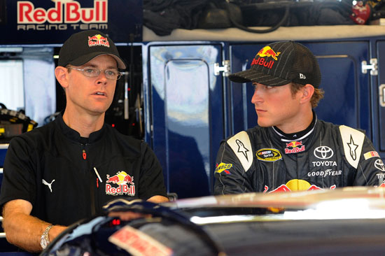 Kasey Kahne (right), driver of the No. 4 Red Bull Toyota, talks with crew chief Kenny Francis (left) in the garage during a rain delay prior to practice for the NASCAR Sprint Cup Series Quaker State 400 at Kentucky Speedway on July 8 in Sparta, Ky. (Credit: John Harrelson/Getty Images)