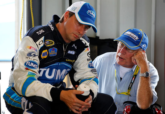 David Reutimann (left), driver of the No. 00 Tums Toyota, talks with his father Buzzy Reutimann (right) in the garage during practice for the NASCAR Sprint Cup Series Quaker State 400 at Kentucky Speedway on July 8 in Sparta, Ky. (Credit: Geoff Burke/Getty Images for NASCAR)