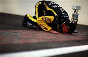 Paul Menard, driver of the #27 NIBCO/Menards Chevrolet, poses as he kisses the bricks after winning the NASCAR Sprint Cup Series Brickyard 400 at Indianapolis Motor Speedway on July 31, 2011 in Indianapolis, Indiana. (Photo by Tom Pennington/Getty Images for NASCAR) photo