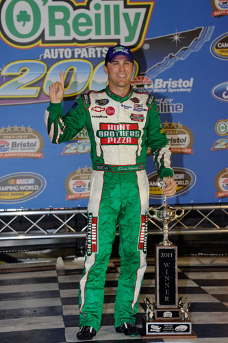 Kevin Harvick celebrates completing the hat trick of national series wins on Wednesday in Bristol Motor Speedway's Victory Lane, adding a NASCAR Camping World Truck Series trophy to his NASCAR Sprint Cup Series and NASCAR Nationwide Series wins. (Credit: John Harrelson/Getty Images for NASCAR)