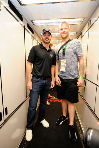 NASCAR Sprint Cup Series five time champion Jimmie Johnson poses with NHL Washington Capitals defenseman Josh Erskine in the No. 48 hauler during pre-race for the NASCAR Sprint Cup Series Good Sam RV Insurance 500 at Pocono Raceway on Aug. 7 in Long Pond, Pa. (Credit: Jared C. Tilton/Getty Images for NASCAR)