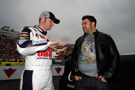 Adam Richman (right), host of Man v. Food, talks with Dale Earnhardt Jr.(left), driver of the No. 88 National Guard/Amp Energy Chevrolet, on the grid during pre race ceremonies prior to the NASCAR Sprint Cup Series Heluva Good! Sour Cream Dips at the Glen at Watkins Glen International on Aug. 14 in Watkins Glen, N.Y. (Credit: Jason Smith/Getty Images for NASCAR)