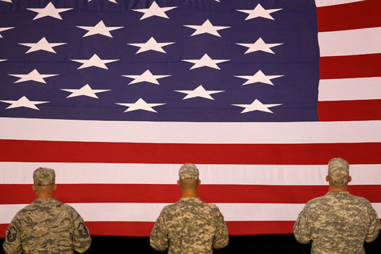 Members of the U.S. military hold the American flag during the prerace ceremony for the NASCAR Sprint Cup Series Wonderful Pistachios 400 on Saturday at Richmond International Raceway. (Credit: Todd Warshaw/Getty Images for NASCAR)