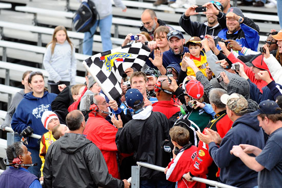 Carl Edwards celebrates with fans in the grandstand after winning the NASCAR Nationwide Series OneMain Financial 200 on Saturday at Dover International Speedway in Dover, Del. (Credit: Jason Smith/Getty Images for NASCAR)