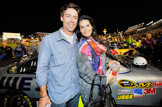 Actress Angie Harmon (R) and former NFL player Jason Sehorn (L), friends of Jimmie Johnson, attend the NASCAR Sprint Cup Series Bank of America 500 at Charlotte Motor Speedway on October 15, 2011 in Charlotte, North Carolina. (Credit: Jason Smith/Getty Images for NASCAR)