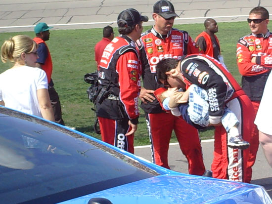 Tony Stewart plays with his crew chief, Darian Grubb's son, Gavin during the pre-race festivities at Kansas Speedway 