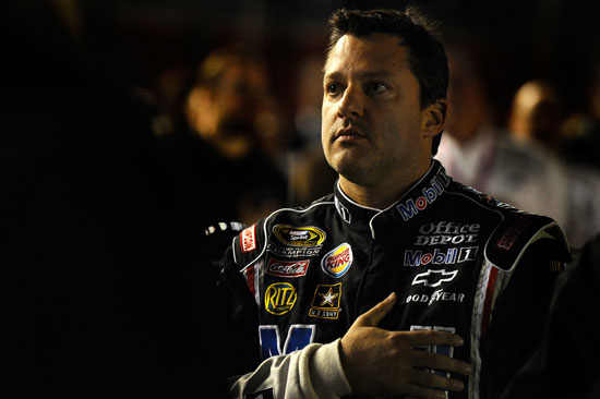 Tony Stewart, driver of the #14 Mobil 1/Office Depot Chevrolet, stands on the grid prior to the NASCAR Sprint Cup Series Bank of America 500 at Charlotte Motor Speedway on October 15, 2011 in Charlotte, North Carolina. (Credit: Jason Smith/Getty Images for NASCAR)