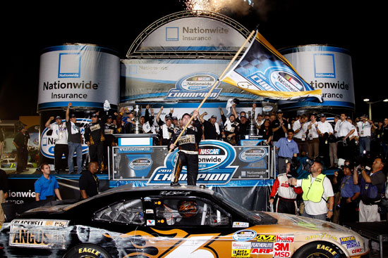 Ricky Stenhouse Jr. hoists a championship flag after clinching the NASCAR Nationwide Series crown at the Ford 300 season finale at Homestead-Miami Speedway on Saturday, Nov. 19. (Credit: By Chris Graythen, Getty Images)