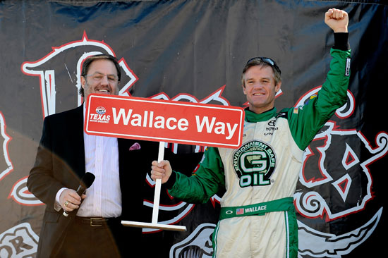 Kenny Wallace, driver of the #09 G-Oil Toyota, is congratulated on stage by Texas Motor Speedway President Eddie Gossage on his 520th NASCAR Nationwide Series race in the O'Reilly Auto Parts Challenge at Texas Motor Speedway on Nov. 5, 2011, in Fort Worth, Texas. (Credit: Jared C. Tilton/Getty Images for NASCAR)