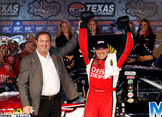 Texas Motor Speedway president Eddie Gossage (left) poses with Tony Stewart, driver of the #14 Office Depot/Mobil 1 Chevrolet, in Victory Lane after Stewart won the NASCAR Sprint Cup Series AAA Texas 500 at Texas Motor Speedway on Nov. 6, 2011, in Fort Worth, Texas. (Credit: Chris Graythen/Getty Images)