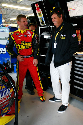 (L-R) Clint Bowyer, driver of the No. 15 5-hour Energy Toyota, talks with team owner Michael Waltrip talk in the garage during practice for the NASCAR Sprint Cup Series STP 400 at Kansas Speedway on Friday in Kansas City, Kan. (Credit: Tyler Barrick/Getty Images)