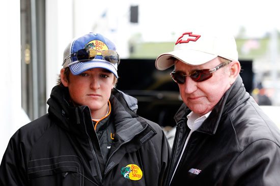 (L-R) Ty Dillon, driver of the No. 3 Bass Pro Shops/Allstate Chevrolet and owner Richard Childress talk in the garage during practice for the NASACAR Camping World Truck Series SFP 250 at Kansas Speedway on Friday in Kansas City, Kansas. (Credit: Geoff Burke/Getty Images for NASCAR)