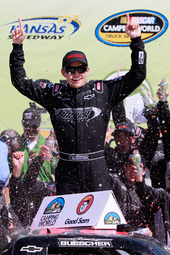James Buescher celebrates in Kansas Speedway's Victory Lane after winning the NASCAR Camping World Truck Series SFP 250 on Saturday in Kansas City, Kan. (Credit: Chris Graythen/Getty Images for NASCAR)