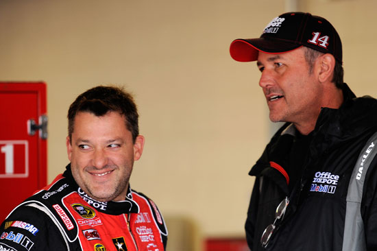 Tony Stewart, driver of the No. 14 Office Depot/Mobil 1 Chevrolet, talks with crew chief Steve Addington in the garage during practice for the NASCAR Sprint Cup Series STP 400 at Kansas Speedway on Friday in Kansas City, Kan. (Credit: John Harrelson/Getty Images for NASCAR)